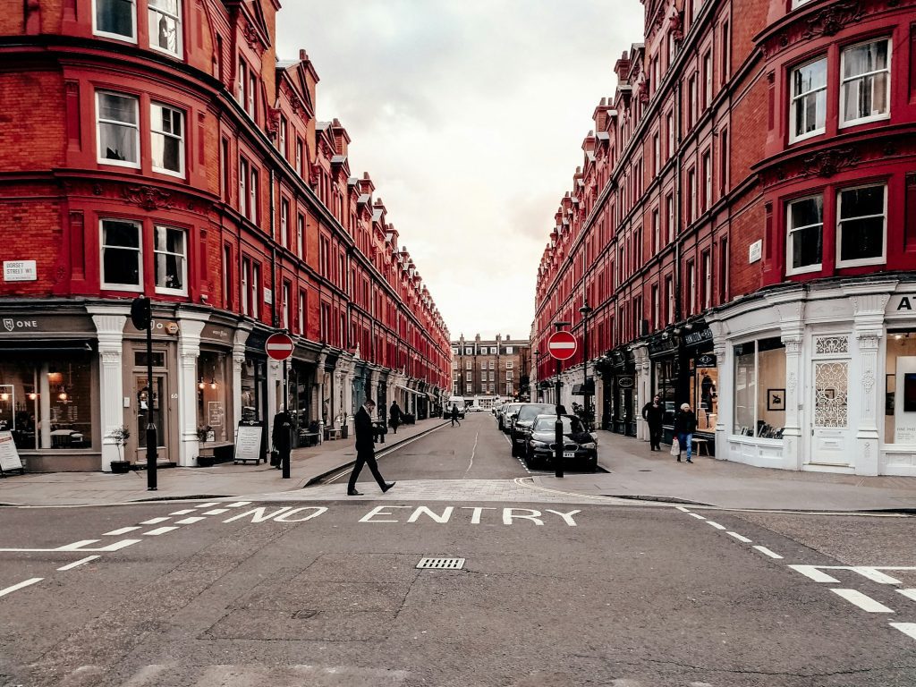 Red brick buildings and shopfronts on a London street