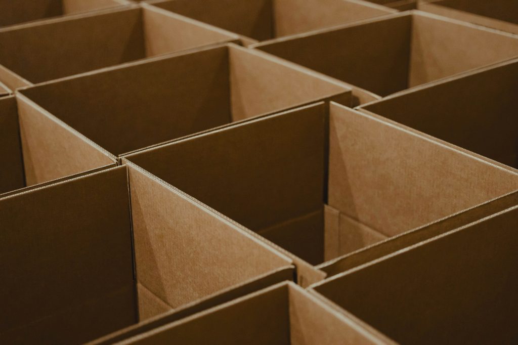 Grid of open brown cardboard boxes ready for packing